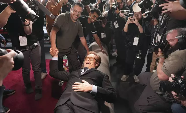 Conan O'Brien, host of Sunday's 97th Academy Awards, poses atop the red carpet during the annual red carpet roll out at the Dolby Theatre on Wednesday, Feb. 26, 2025, in Los Angeles. (AP Photo/Chris Pizzello)