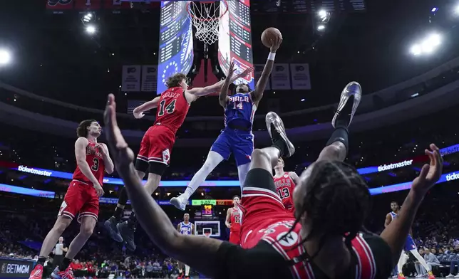 Philadelphia 76ers' Ricky Council IV, right, goes up for a shot against Chicago Bulls' Matas Buzelis during the second half of an NBA basketball game Monday, Feb. 24, 2025, in Philadelphia. (AP Photo/Matt Slocum)
