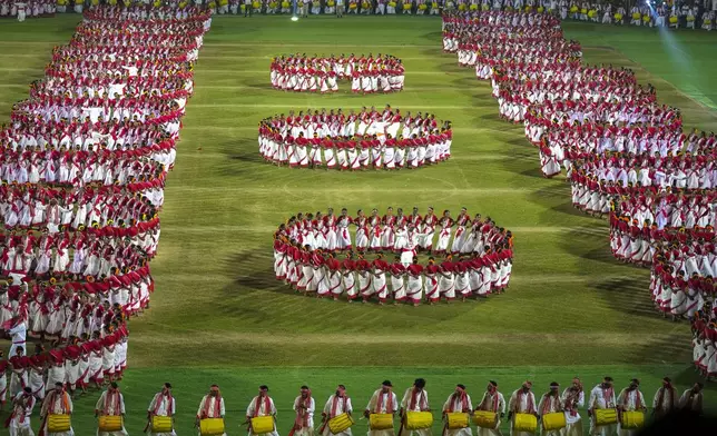Tribal youth perform Jhumur dance during a dance event attempting a world record in Guwahati, India, Monday, Feb. 24, 2025. (AP Photo/Anupam Nath)