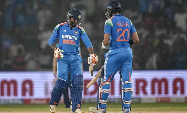India's Ravindra Jadeja, left, and Axar Patel celebrate after winning the second one day international cricket match against England in Cuttack, India, Sunday, Feb. 9, 2025. (AP Photo/Rafiq Maqbool)