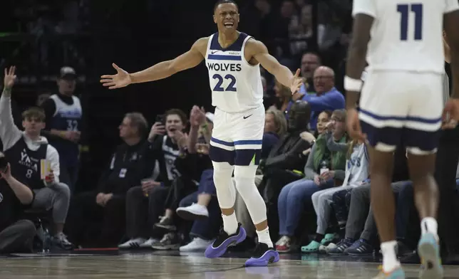 Minnesota Timberwolves guard Jaylen Clark (22) celebrates after scoring a 3-point basket during the second half of an NBA basketball game against the Portland Trail Blazers, Saturday, Feb. 8, 2025, in Minneapolis. (AP Photo/Ellen Schmidt)