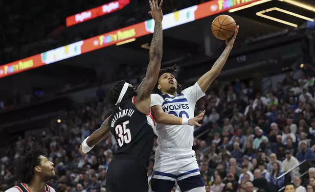 Minnesota Timberwolves guard Terrence Shannon Jr. (00) shoots against Portland Trail Blazers center Robert Williams III during the first half of an NBA basketball game, Saturday, Feb. 8, 2025, in Minneapolis. (AP Photo/Ellen Schmidt)