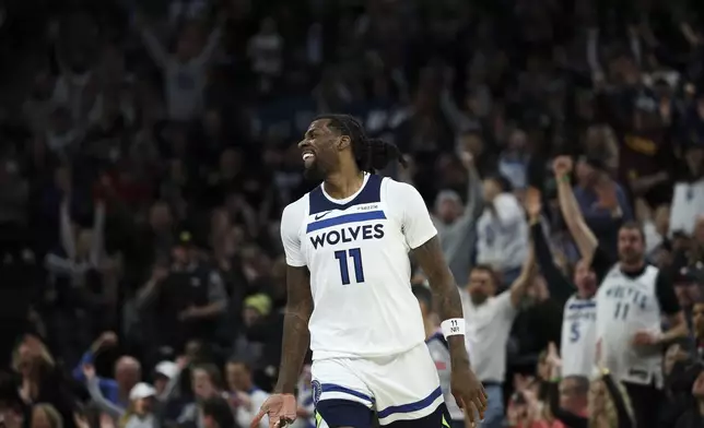 Minnesota Timberwolves center Naz Reid celebrates after scoring a 3-point basket during the second half of an NBA basketball game against the Portland Trail Blazers, Saturday, Feb. 8, 2025, in Minneapolis. (AP Photo/Ellen Schmidt)