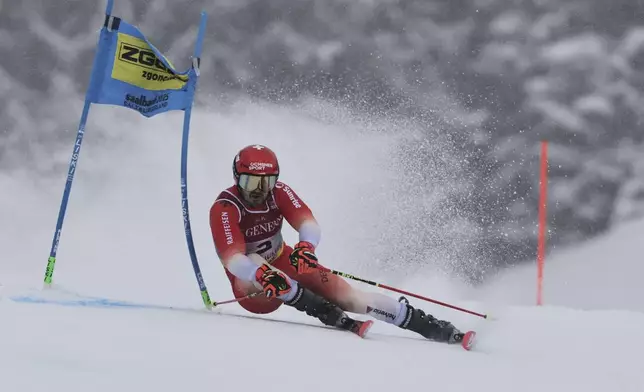 Switzerland's Loic Meillard competes in a men's giant slalom, at the Alpine Ski World Championships, in Saalbach-Hinterglemm, Austria, Friday, Feb. 14, 2025. (AP Photo/Marco Trovati)