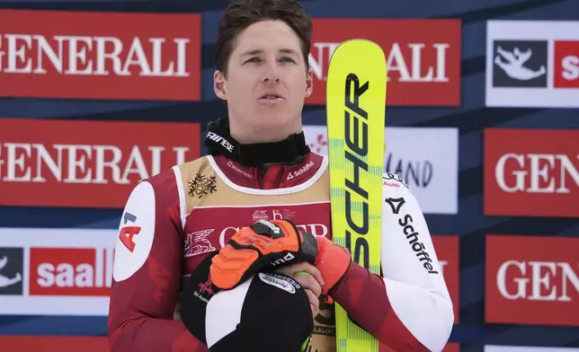 Austria's Raphael Haaser listens to the national anthem after winning the gold medal in a men's giant slalom, at the Alpine Ski World Championships, in Saalbach-Hinterglemm, Austria, Friday, Feb. 14, 2025. (AP Photo/Giovanni Auletta)