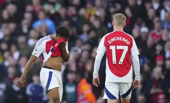 Arsenal's Myles Lewis-Skelly, left, reacts after receiving a red card during the English Premier League soccer match between Arsenal and West Ham United at Emirates stadium in London, Saturday, Feb. 22, 2025. (AP Photo/Kirsty Wigglesworth)