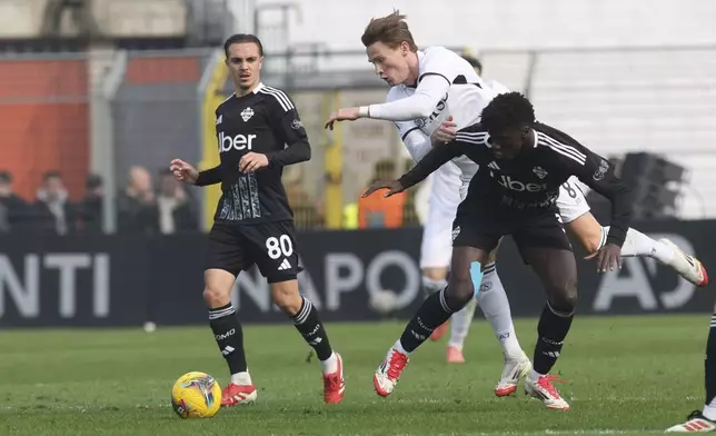 SSC Napoli's Scott McTominay, center, in action during the Italian Serie A between soccer match between Como and Napoli at the Giuseppe Sinigaglia stadium in Como, north Italy, Sunday, Feb. 23, 2025. (Antonio Saia/LaPresse via AP)