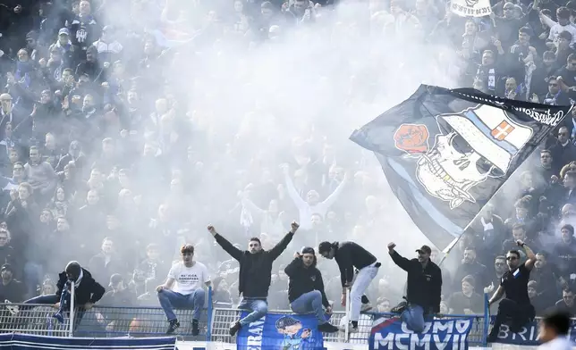 Como supporters celebrate during the Italian Serie A between soccer match between Como and Napoli at the Giuseppe Sinigaglia stadium in Como, north Italy, Sunday, Feb. 23, 2025. (Antonio Saia/LaPresse via AP)