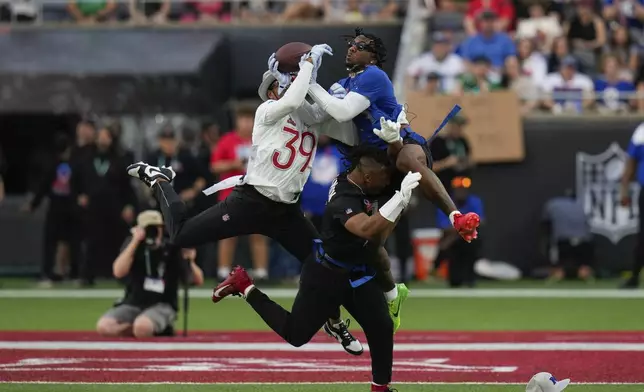 NFC wide receiver Malik Nabers, of the New York Giants, right, catches a pass while defended by AFC safety Minkah Fitzpatrick (39), of the Pittsburgh Steelers, during the flag football event at the NFL Pro Bowl, Sunday, Feb. 2, 2025, in Orlando. (AP Photo/Chris O'Meara)