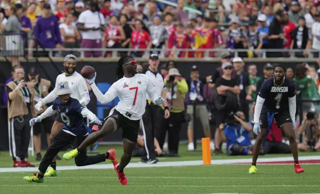 AFC wide receiver Brian Thomas Jr. (7), of the Jacksonville Jaguars, evades NFC return specialist KaVontae Turpin (9), of the Dallas Cowboys, as he throws a lateral pass during the flag football event at the NFL Pro Bowl, Sunday, Feb. 2, 2025, in Orlando. (AP Photo/Chris O'Meara)