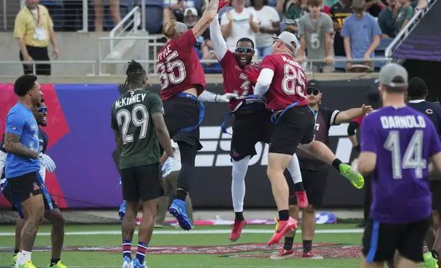 NFC safety Budda Baker (3), of the Arizona Cardinals, celebrates with tight ends George Kittle, of the San Francisco 49ers, and Trey McBride, of the Cardinals, after returning an interception for a touchdown during the flag football event at the NFL Pro Bowl, Sunday, Feb. 2, 2025, in Orlando. (AP Photo/John Raoux)