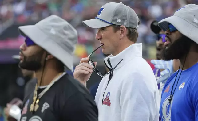NFC coach Eli Manning, center, watches from the sideline during the flag football event at the NFL Pro Bowl, Sunday, Feb. 2, 2025, in Orlando. (AP Photo/John Raoux)