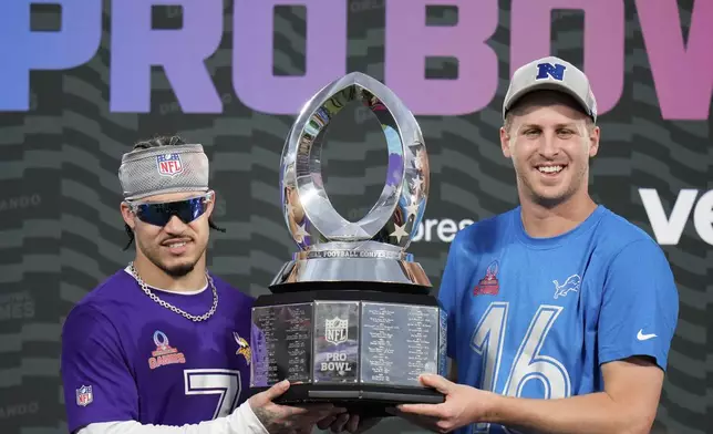 NFC cornerback Byron Murphy, left, of the Minnesota Vikings, and quarterback Jared Goff, right, of the Detroit Lions, hold the 2025 Pro Bowl trophy after being named defensive and offensive MVPs, respectively, for the flag football event at the NFL Pro Bowl, Sunday, Feb. 2, 2025, in Orlando. (AP Photo/Chris O'Meara)