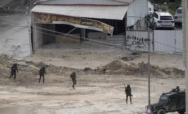 Israeli forces move through the West Bank Nur Shams refugee camp during an ongoing military operation on Wednesday, Feb. 12, 2025. (AP Photo/Majdi Mohammed)