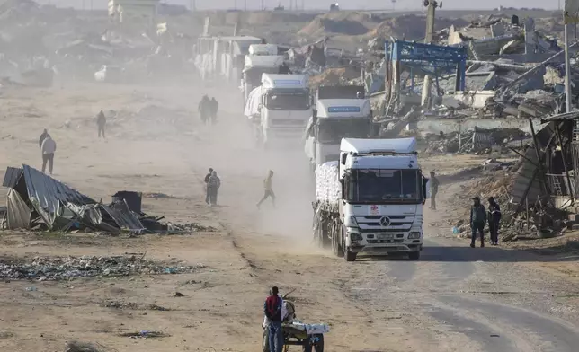 Trucks carrying humanitarian aid enter the Gaza Strip from Egypt in the southern Gaza town of Rafah, Wednesday, Feb. 12, 2025.(AP Photo/Abdel Kareem Hana)