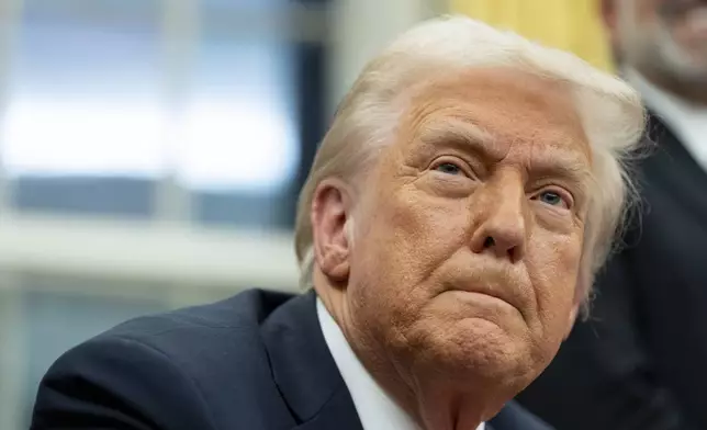 FILE - President Donald Trump speaks with reporters as he signs executive orders in the Oval Office at the White House, Monday, Feb. 10, 2025, in Washington. (AP Photo/Alex Brandon, file)