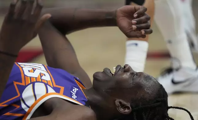 Phoenix Suns center Bol Bol (11) lays on the ground after blocking a shot from the Chicago Bulls during the first half of an NBA basketball game Saturday, Feb. 22, 2025, in Chicago. (AP Photo/Erin Hooley)