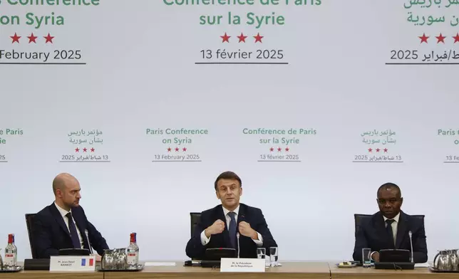 France's President Emmanuel Macron, center, delivers a speech during the International Conference on Syria at the Ministerial Conference Center, in Paris, France, Thursday, Feb. 13, 2025. (Ludovic Marin, Pool Photo via AP)