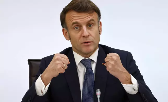 France's President Emmanuel Macron gestures as he delivers a speech during the International Conference on Syria at the Ministerial Conference Center, in Paris, France, Thursday, Feb. 13, 2025. (Ludovic Marin, Pool Photo via AP)