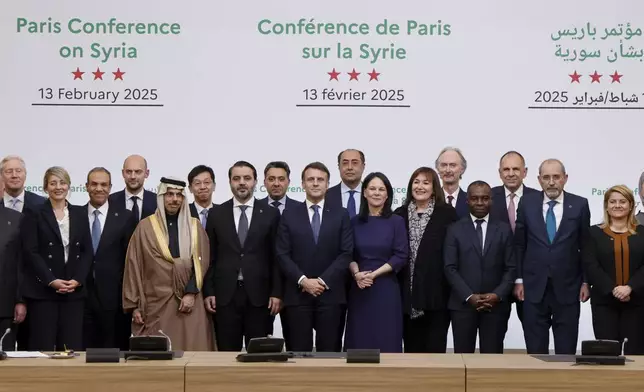 France's President Emmanuel Macron, center left, and on his side Syria's Interim Foreign Minister Asaad Al-Shibani pose for a photo with participants during the International Conference on Syria at the Ministerial Conference Center, in Paris, France, Thursday, Feb. 13, 2025. (Ludovic Marin, Pool Photo via AP)