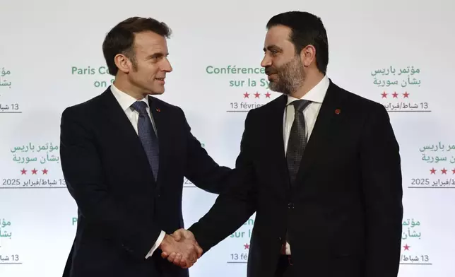 France's President Emmanuel Macron, left, greets Syria's Interim Foreign Minister Asaad Al-Shibani during the International Conference on Syria at the Ministerial Conference Center, in Paris, France, Thursday, Feb. 13, 2025. (Ludovic Marin, Pool Photo via AP)