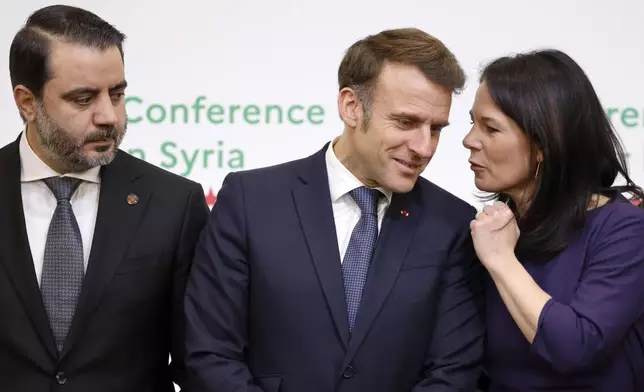 France's President Emmanuel Macron, center, Syria's Interim Foreign Minister Asaad Al-Shibani, left, and German Foreign Minister Annalena Baerbock pose for a photo during the International Conference on Syria at the Ministerial Conference Center, in Paris, France, Thursday, Feb. 13, 2025. (Ludovic Marin, Pool Photo via AP)