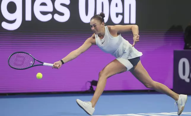 Amanda Anisimova of the United States returns to Latvia's Jelena Ostapenko during the Qatar Open tennis tournament final in Doha, Qatar, on Saturday, Feb. 15, 2025. (AP Photo/Hussein Sayed)