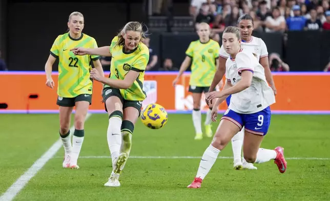 Australia defender Winonah Heatley (3) kicks the ball past United States forward Ally Sentnor (9) during the second half of a group stage match in the SheBelieves Cup women's soccer tournament, Sunday, Feb. 23, 2025, in Glendale, Ariz. (AP Photo/Samantha Chow)