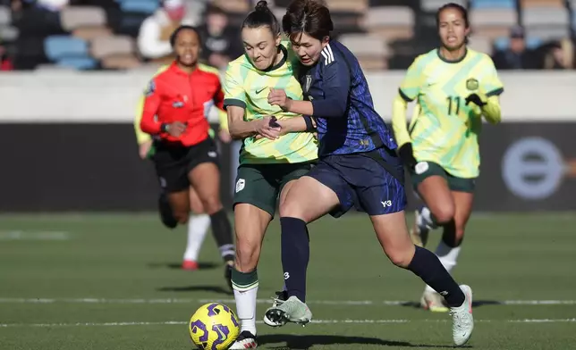 Australia forward Caitlin Foord, left, and Japan defender Toko Koga, right, battle for the ball during the SheBelieves Cup women's soccer tournament, Thursday, Feb. 20, 2025, in Houston. (AP Photo/Michael Wyke)