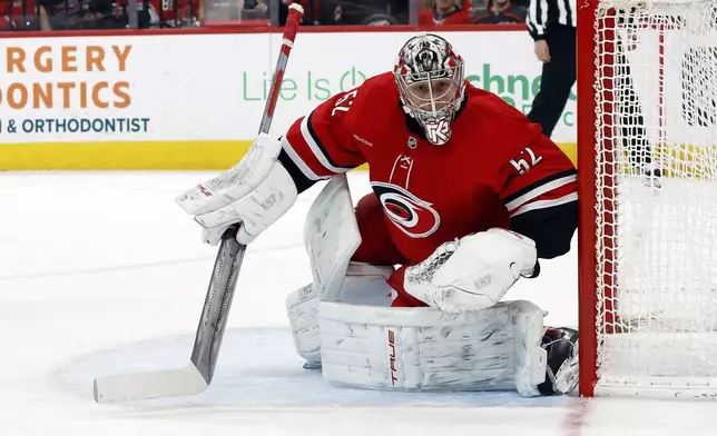 Carolina Hurricanes goaltender Pyotr Kochetkov (52) watches the puck against the Utah Hockey Club during the first period of an NHL hockey game in Raleigh, N.C., Saturday, Feb. 8, 2025. (AP Photo/Karl DeBlaker)
