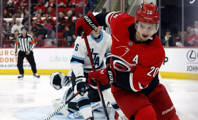 Carolina Hurricanes' Sebastian Aho (20) controls the puck against the Utah Hockey Club during the second period of an NHL hockey game in Raleigh, N.C., Saturday, Feb. 8, 2025. (AP Photo/Karl DeBlaker)