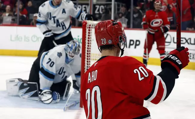 Carolina Hurricanes' Sebastian Aho (20) celebrates his goal while acknowledging his teammate Seth Jarvis (24) for the pass during the second period of an NHL hockey game against the Utah Hockey Club in Raleigh, N.C., Saturday, Feb. 8, 2025. (AP Photo/Karl DeBlaker)