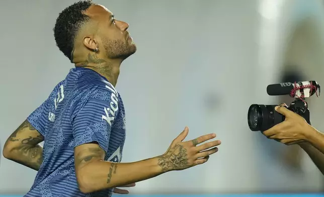 Brazil's Neymar warms up before his debut match for Santos FC in a Sao Paulo league soccer game against Botafogo-SP in Santos, Brazil, Wednesday, Feb. 5, 2025. (AP Photo/Andre Penner)
