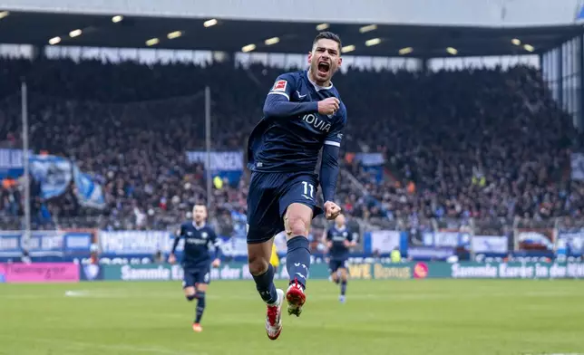Bochum's Georgios Masouras celebrates after scoring his side's second goal during the German Bundesliga soccer match between VfL Bochum and Borussia Dortmund in Bochum, Germany, Saturday, Feb. 15, 2025. (David Inderlied/dpa via AP)