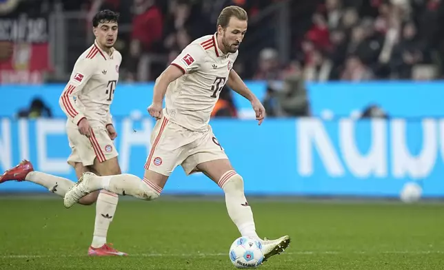 Bayern's Harry Kane, centre, in action during the German Bundesliga soccer match between Bayer Leverkusen and FC Bayern Munich at the BayArena in Leverkusen, Germany, Saturday, Feb. 15, 2025. (AP Photo/Martin Meissner)