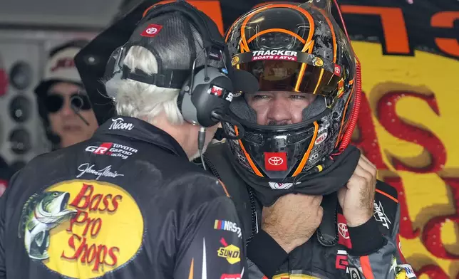 Martin Truex Jr., right, talks to a crew member during a practice for the NASCAR Daytona 500 auto race Wednesday, Feb. 12, 2025, at Daytona International Speedway in Daytona Beach, Fla. (AP Photo/Chris O'Meara)
