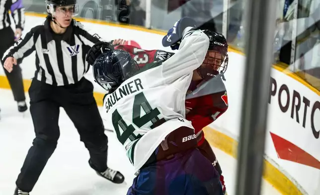 Boston Fleet's Jill Saulnier (44) and Ottawa Charge's Tereza Vanisova (13) exchange punches during third period PWHL hockey action in Ottawa, on Thursday, Feb. 20, 2025. (Justin Tang/The Canadian Press via AP)