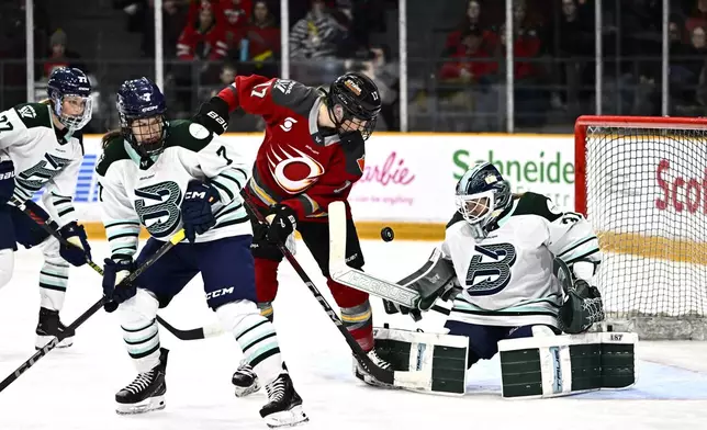 Ottawa Charge's Gabbie Hughes (17) looks for a chance on Boston Fleet goaltender Aerin Frankel (31) during third period PWHL hockey action in Ottawa, on Thursday, Feb. 20, 2025. (Justin Tang/The Canadian Press via AP)