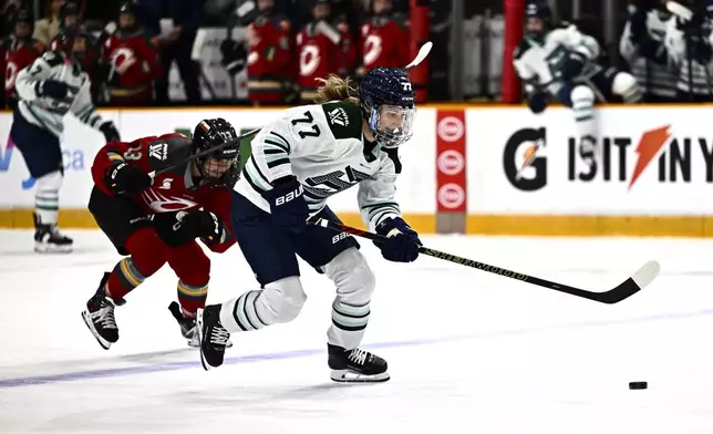 Boston Fleet's Susanna Tapani (77) breaks away past Ottawa Charge's Tereza Vanisova (13), leading to her game winning goal, during overtime period PWHL hockey action in Ottawa, on Thursday, Feb. 20, 2025. (Justin Tang/The Canadian Press via AP)