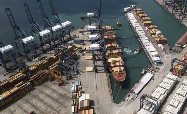 Cranes load and unload containers from cargo ships at the Cristobal port, operated by the Panama Ports Company, in Colon, Panama, Tuesday, Feb. 4, 2025. (AP Photo/Matias Delacroix)