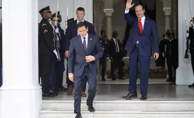 Panama's Foreign Minister Javier Martinez-Acha waves to U.S. Secretary of State Marco Rubio as he departs the presidential palace in Panama City after meeting with President Jose Mulino, Sunday, Feb. 2, 2025. (AP Photo/Mark Schiefelbein, Pool)