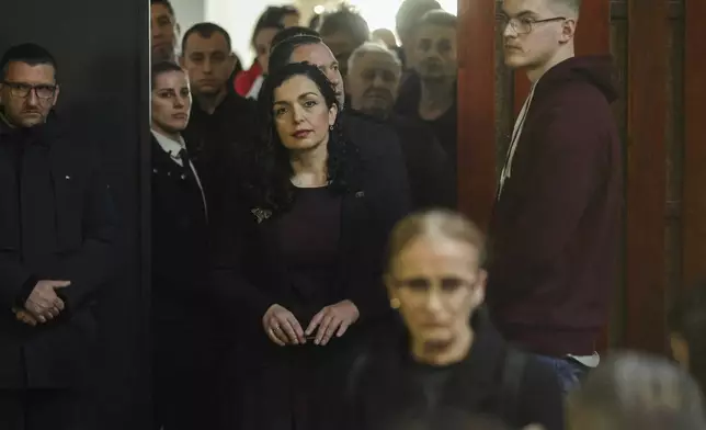 Kosovo's President Vjosa Osmani waits in line before casting her ballot during parliamentary election in Pristina, Kosovo, Sunday, Feb. 9, 2025. (AP Photo/Vlasov Sulaj)