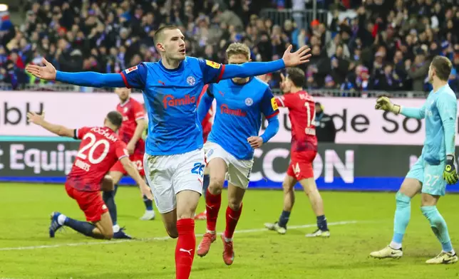 Kiel's David Zec celebrates scoring during the Bundesliga soccer match between Holstein Kiel - VfL Bochum at the Holstein-Stadion, Kiel, Germany, Sunday Feb. 9, 2025. (Frank Molter/dpa via AP)