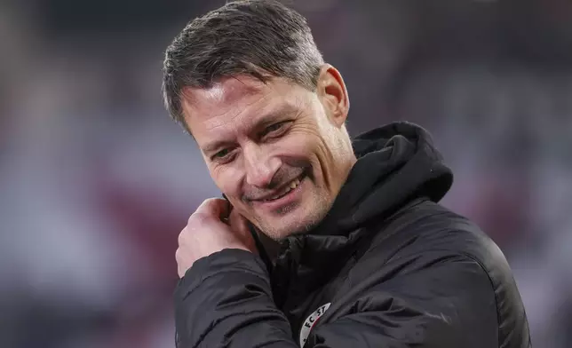 St. Pauli coach Alexander Blessin arrives at the stadium before a Bundesliga soccer match against Leipzig, Sunday, Feb. 9, 2025. (Jan Woitas/dpa via AP)