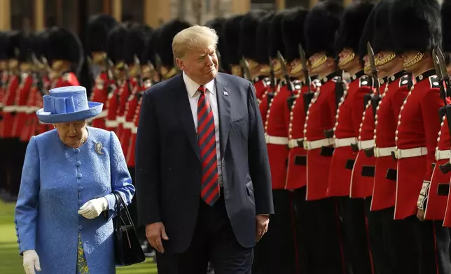 FILE - President Donald Trump and Britain's Queen Elizabeth II inspect a Guard of Honour, formed of the Coldstream Guards at Windsor Castle in Windsor, England, July 13, 2018. (AP Photo/Matt Dunham, Pool, File)