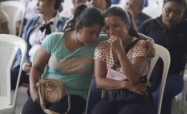 Mourners attend a funeral service for victims of a bus crash, in Santo Domingo Los Ocotes, Guatemala, Tuesday, Feb. 11, 2025. Dozens of passengers died after their bus plunged into a gorge and landed under a bridge on Feb. 10 on the outskirts of the Guatemalan capital. (AP Photo/Moises Castillo)