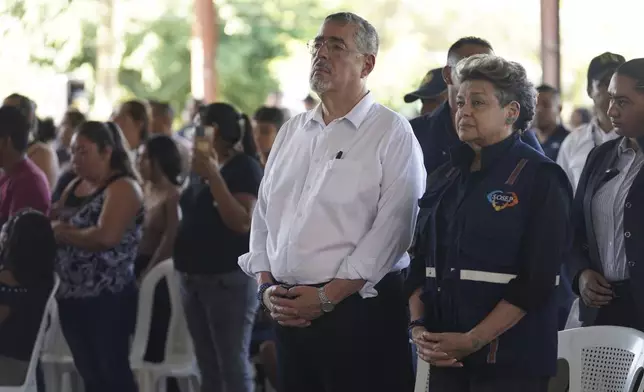 Guatemalan President Bernardo Arévalo and first lady Lucrecia Peinado, pay their final respects to the victims of a bus crash, at a funeral service in Santo Domingo Los Ocotes, Guatemala, Tuesday, Feb. 11, 2025. Dozens of passengers died after their bus plunged into a gorge and landed under a bridge on Feb. 10 on the outskirts of the Guatemalan capital. (AP Photo/Moises Castillo)