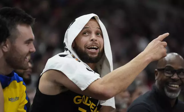 Golden State Warriors guard Stephen Curry, center, reacts on the bench during the second half of an NBA basketball game against the Chicago Bulls, Saturday, Feb. 8, 2025, in Chicago. (AP Photo/Erin Hooley)