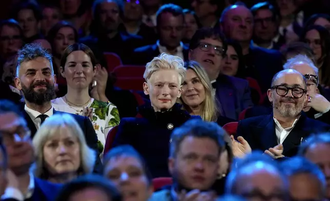 Tilda Swinton sits in the audience during the opening of the International Film Festival, Berlinale, in Berlin, Thursday, Feb. 13, 2025. (AP Photo/Markus Schreiber)
