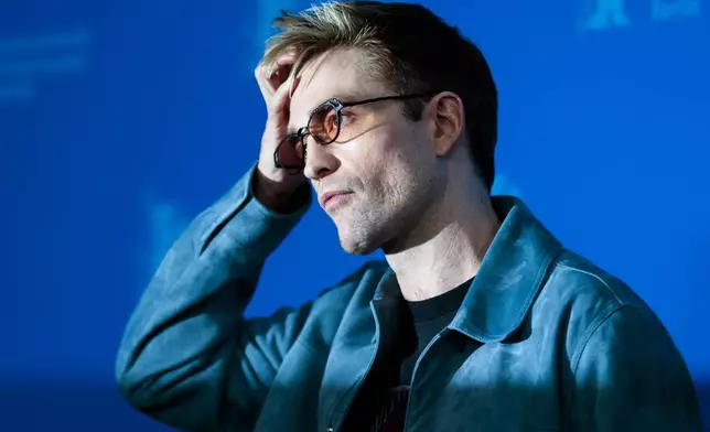 Robert Pattinson poses for photographer at the photo call for the film 'Mickey 17' at the International Film Festival, Berlinale, in Berlin, Saturday, Feb. 15, 2025. (AP Photo/Markus Schreiber)